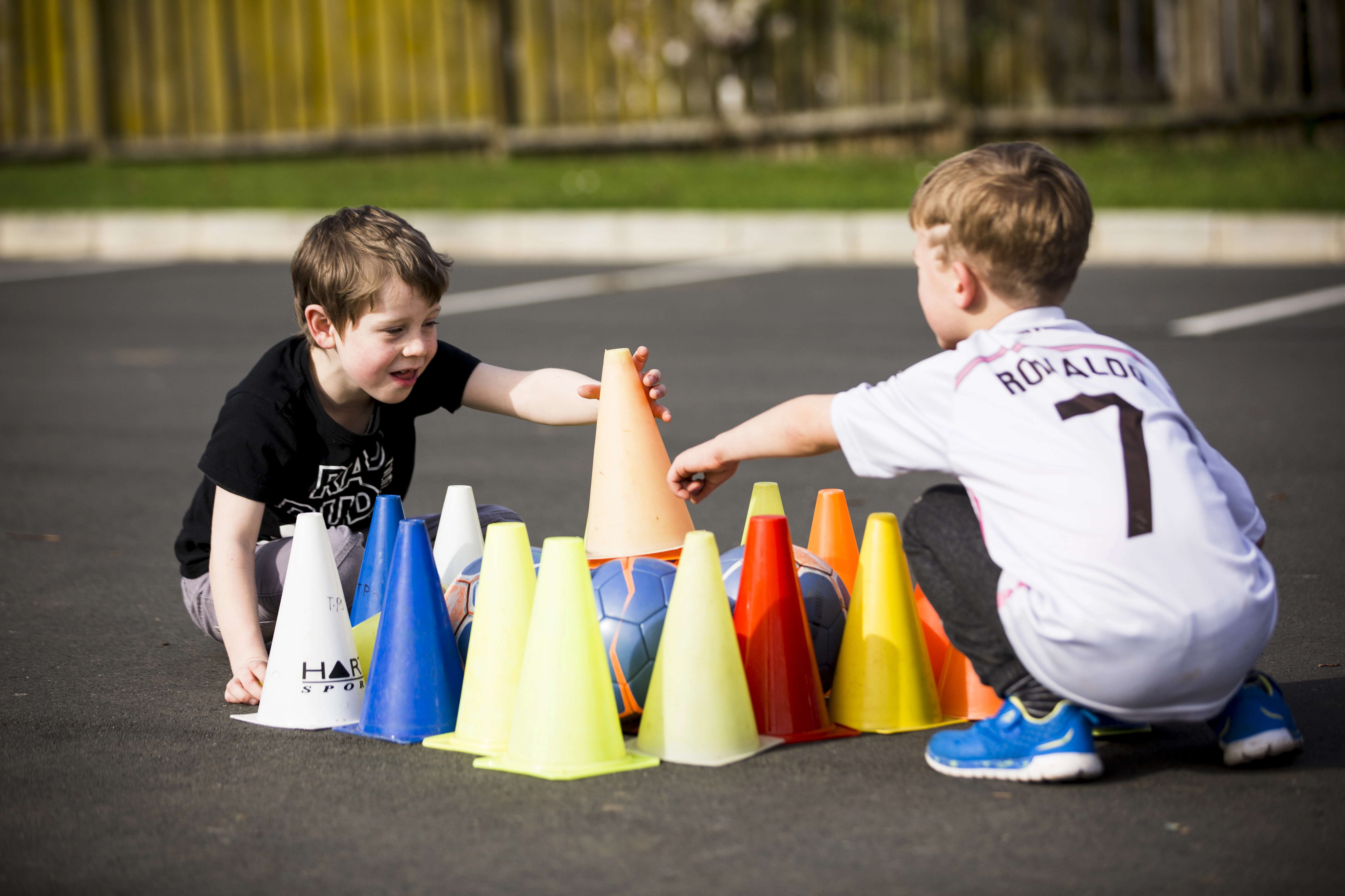 Two kids playing with cones